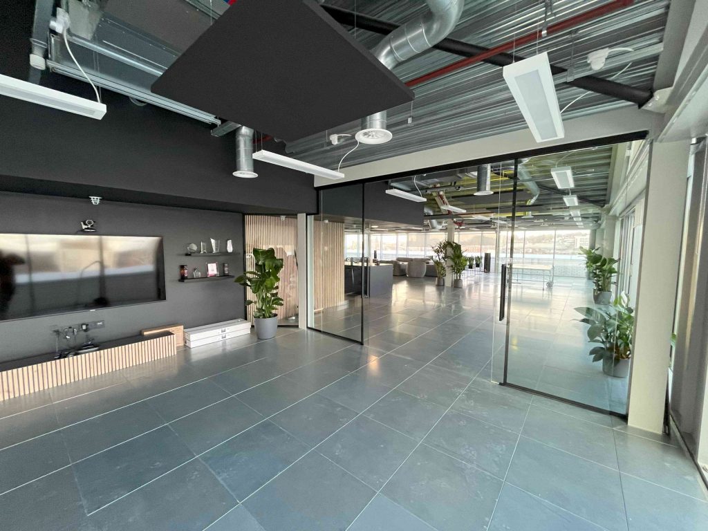 completed office fit out in london with glass partition walls and acoustic slatted wood partitioning