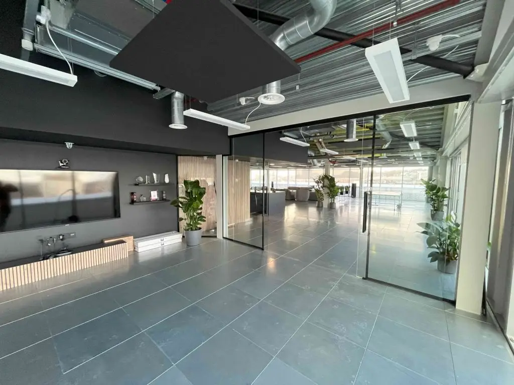 completed office fit out in london with glass partition walls and acoustic slatted wood partitioning