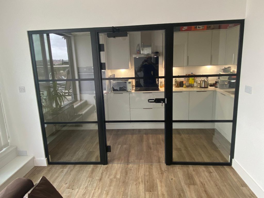 photo of a fire rated glass partition with glass door in a kitchen