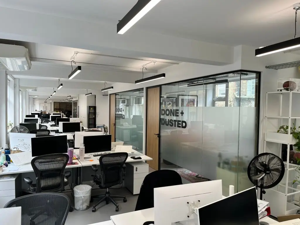 Photo of obscured office glass partitioning with modern signage and manifestation
