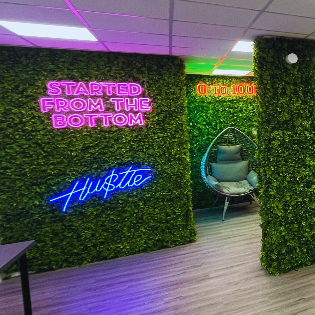 Decorating fake live wall in an office with bright neon lights. newly decorated office.