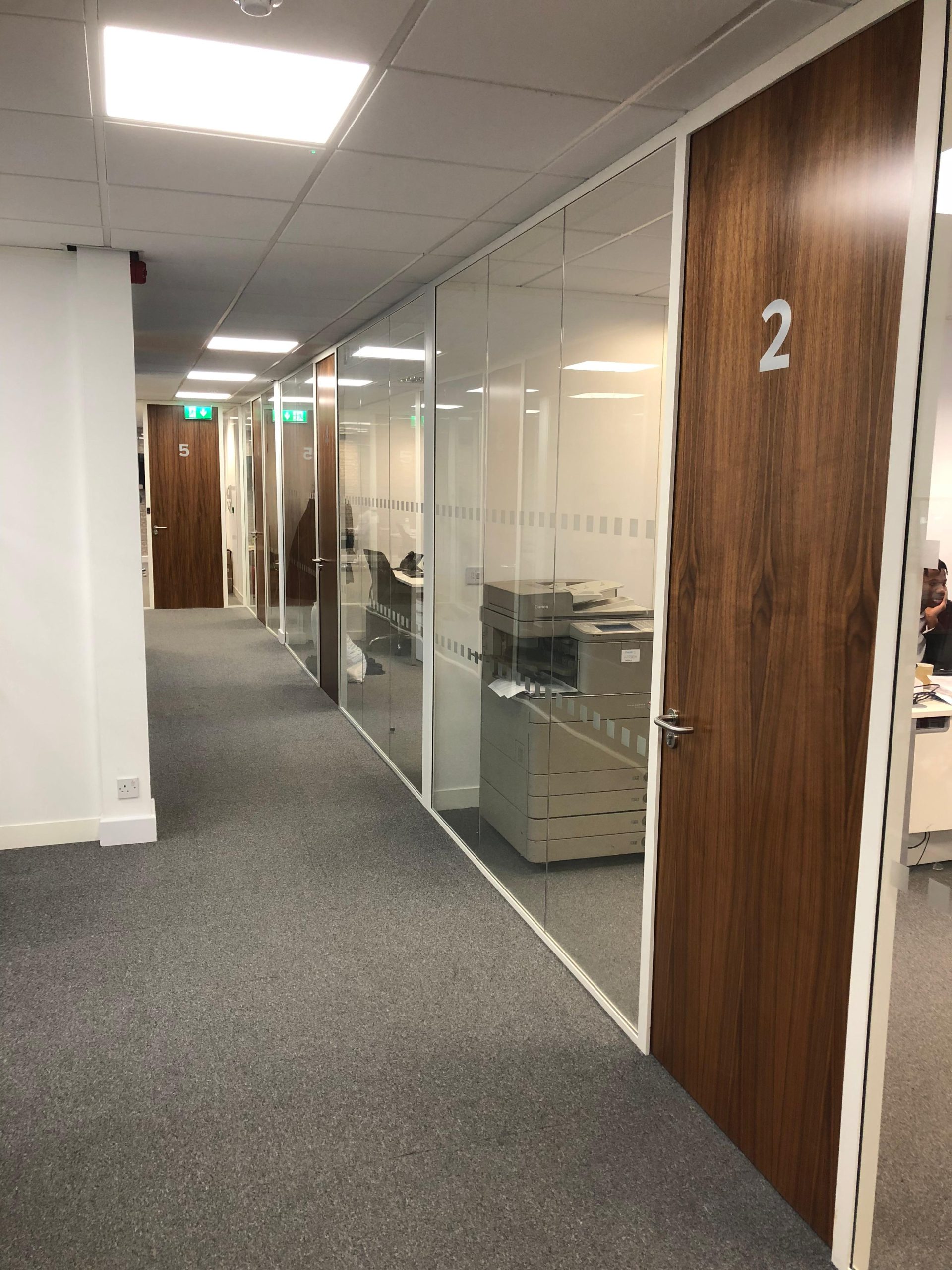 Office coridoor with glass partitions and wooden fire rated office doors